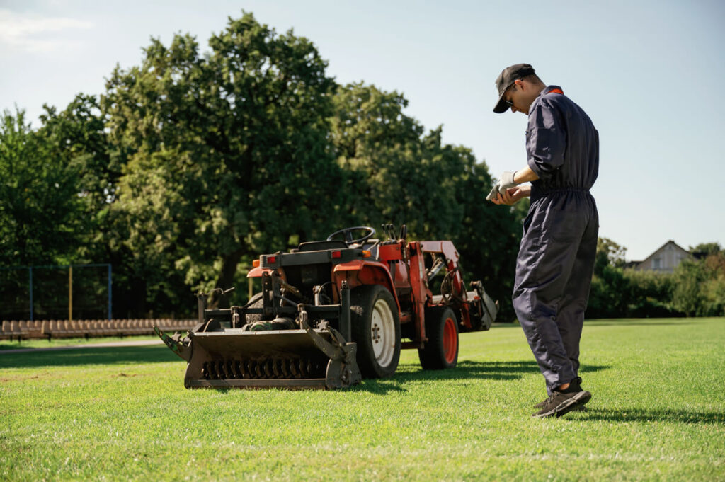 Back view walking man is with utility tractor wi TLPQ29W 1024x681